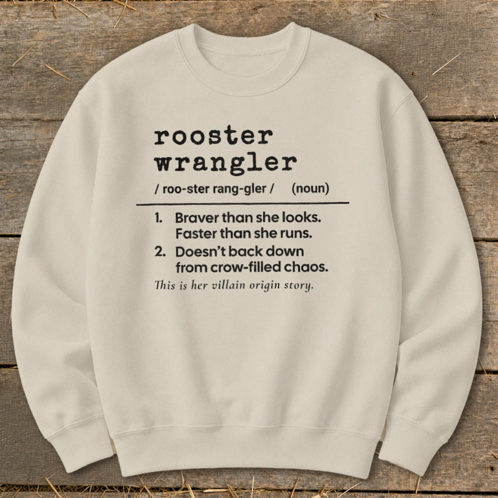 Cream sweatshirt with "rooster wrangler" definition: "Braver than she looks..."