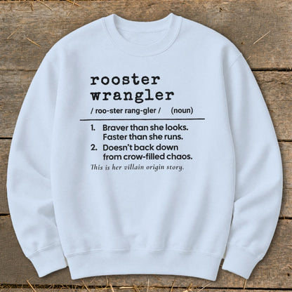 White sweatshirt with "Rooster Wrangler" definition and "villain origin story" text.