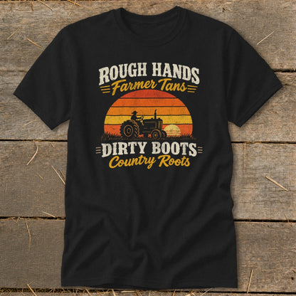 Black t-shirt featuring a retro graphic of a tractor at sunset with the text "Rough Hands, Farmer Tans, Dirty Boots, Country Roots."