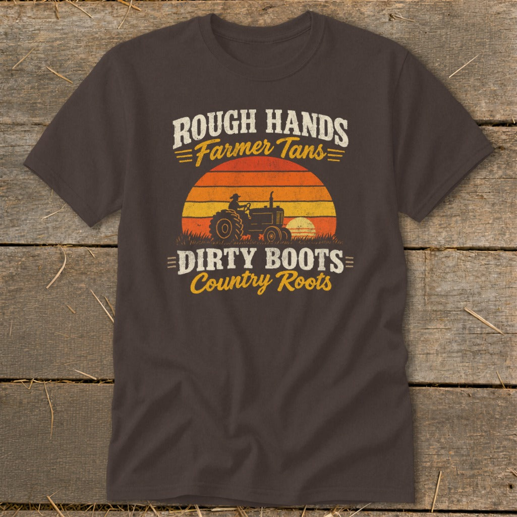 A brown t-shirt featuring a distressed graphic of a tractor, sunset, and text reading Rough Hands Farmer Tans Dirty Boots Country Roots.