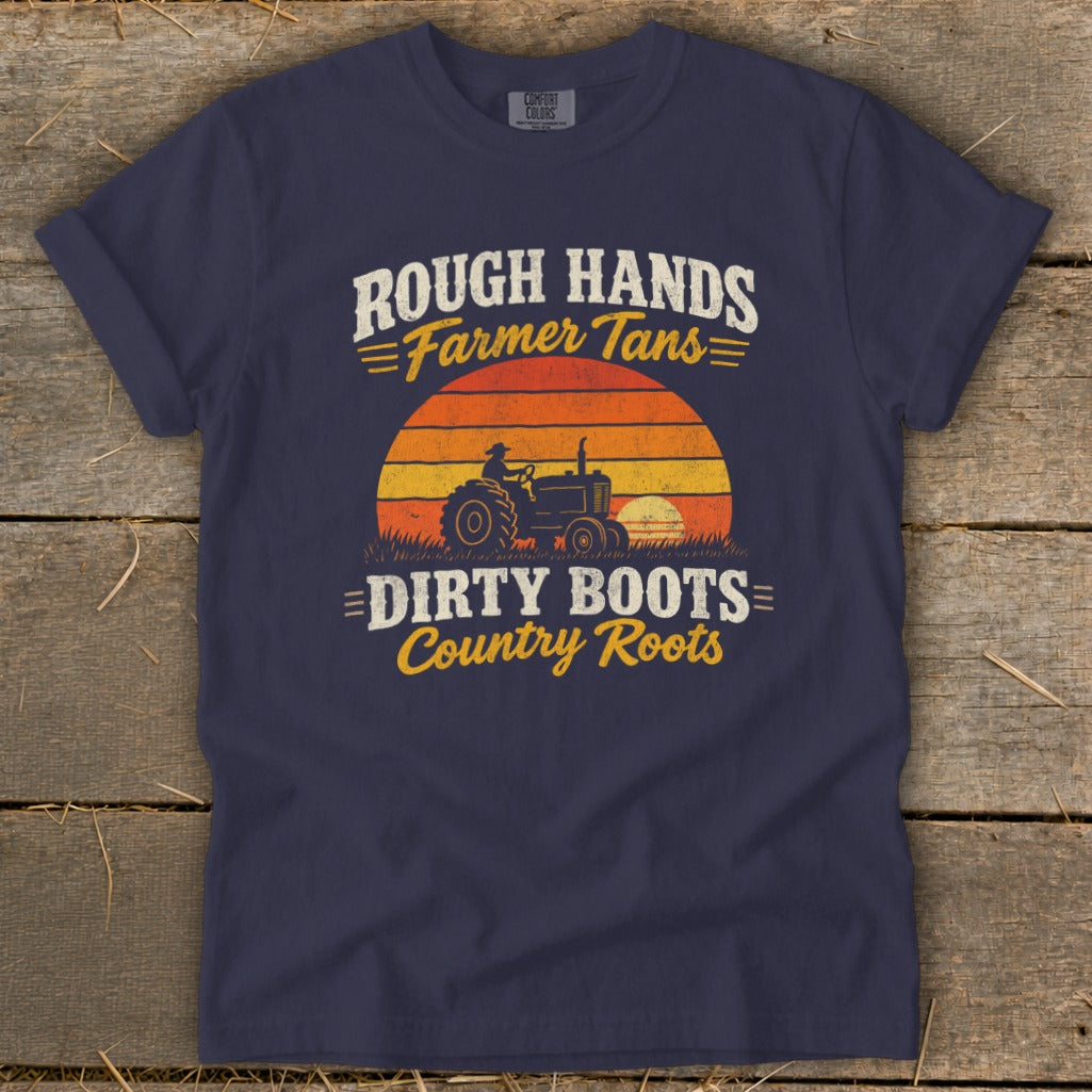 Navy blue t-shirt featuring distressed text reading Rough Hands Farmer Tans Dirty Boots Country Roots over a retro tractor and sunset graphic.