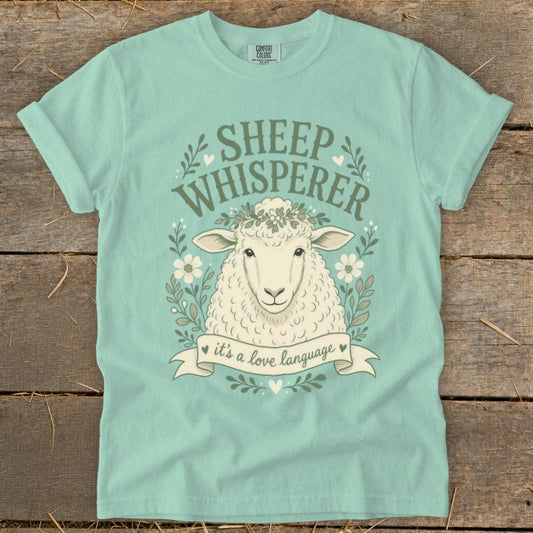 Mint t-shirt with "Sheep Whisperer" text and a sheep wearing a flower crown.