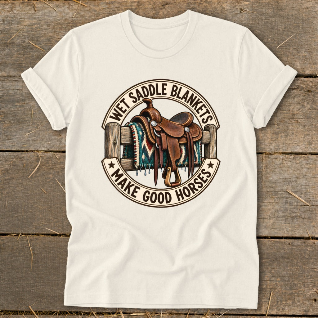 Western saddle on a fence with blanket, text "Wet Saddle Blankets Make Good Horses".