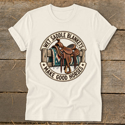Western saddle on a fence with blanket, text "Wet Saddle Blankets Make Good Horses".