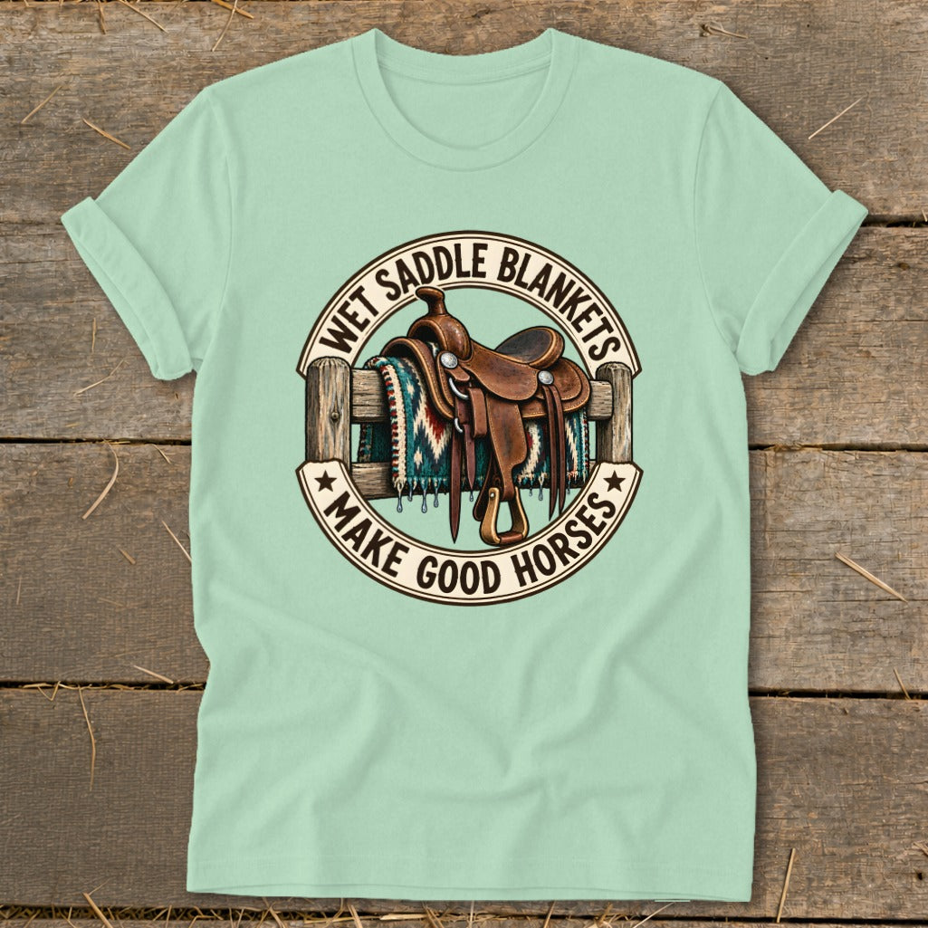 Light green t-shirt with "Wet Saddle Blankets Make Good Horses" and saddle graphic.