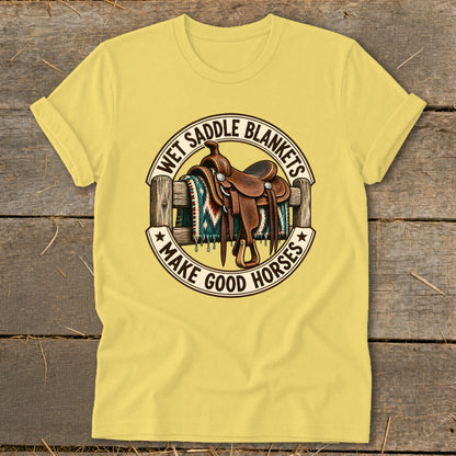 Yellow t-shirt with western saddle on a fence and text "Wet Saddle Blankets Make Good Horses".