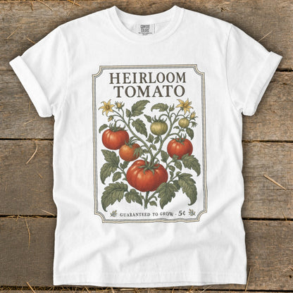 White t-shirt with "Heirloom Tomato" text and vintage illustration of tomato plant.