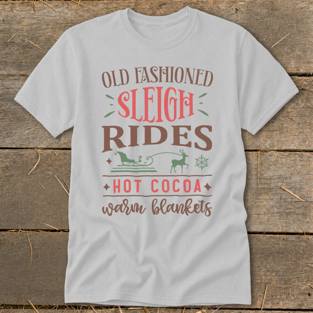 White t-shirt with "Old Fashioned Sleigh Rides, Hot Cocoa Warm Blankets" text and graphics.