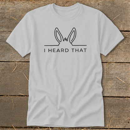 Light gray t-shirt with black line art of donkey ears and "I HEARD THAT" text.