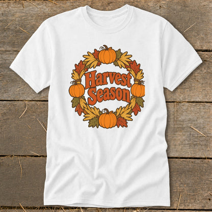 White t-shirt with "Harvest Season" text surrounded by pumpkins and autumn leaves.
