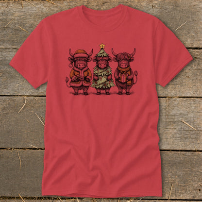 Three Highland cows dressed for Christmas, one in a Santa suit, one as a tree, one with a gift.