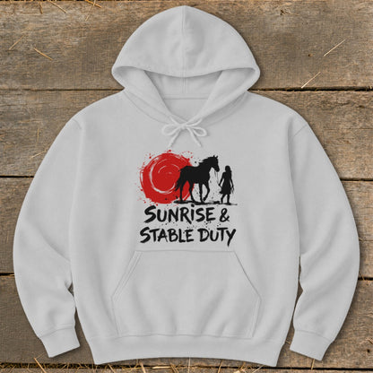 White hoodie with black horse and rider silhouette over red sun, text reads Sunrise & Stable Duty.