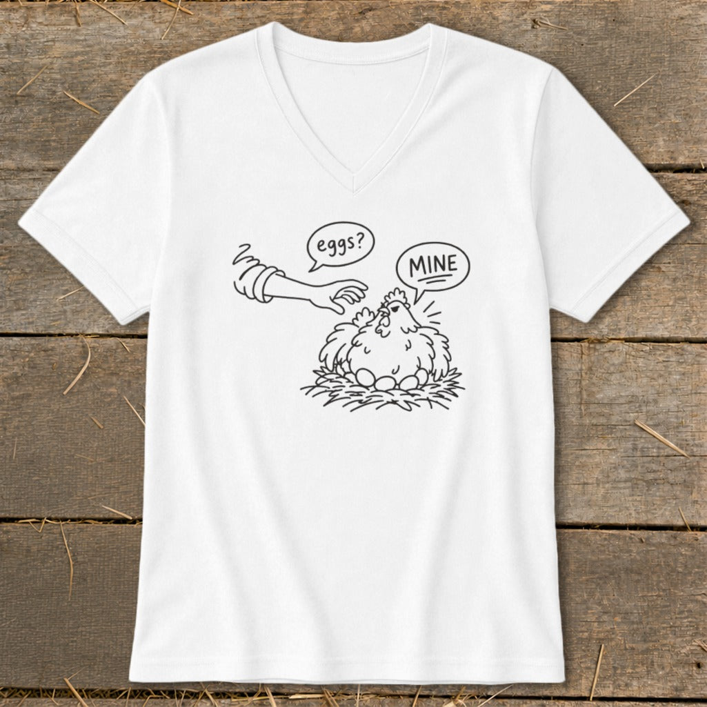 White t-shirt with a cartoon of a hen protecting her eggs, saying "MINE".