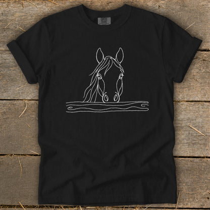 Black t-shirt with white line drawing of a horse's head above wooden planks.