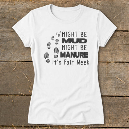 White t-shirt with black text and boot prints: "Might be Mud, Might be Manure. It's Fair Week."