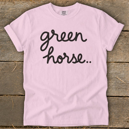 Pink t-shirt with "green horse.." in black script text.