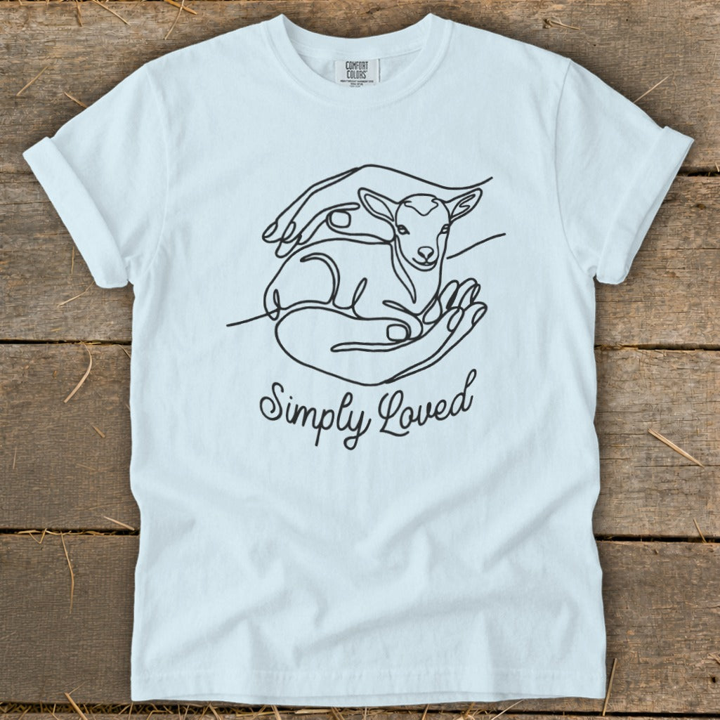 Light blue t-shirt with a line drawing of hands holding a lamb and the text "Simply Loved".