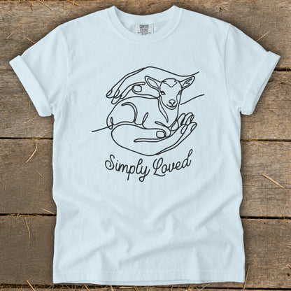 Light blue t-shirt with a line drawing of hands holding a lamb and the text "Simply Loved".
