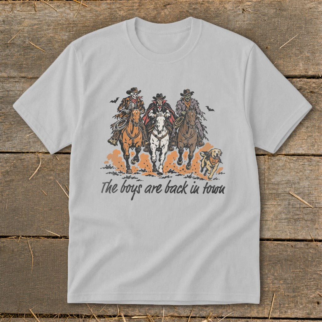 Skeleton cowboys and a vampire ride horses with text "The boys are back in town."