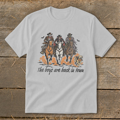 Skeleton cowboys and a vampire ride horses with text "The boys are back in town."