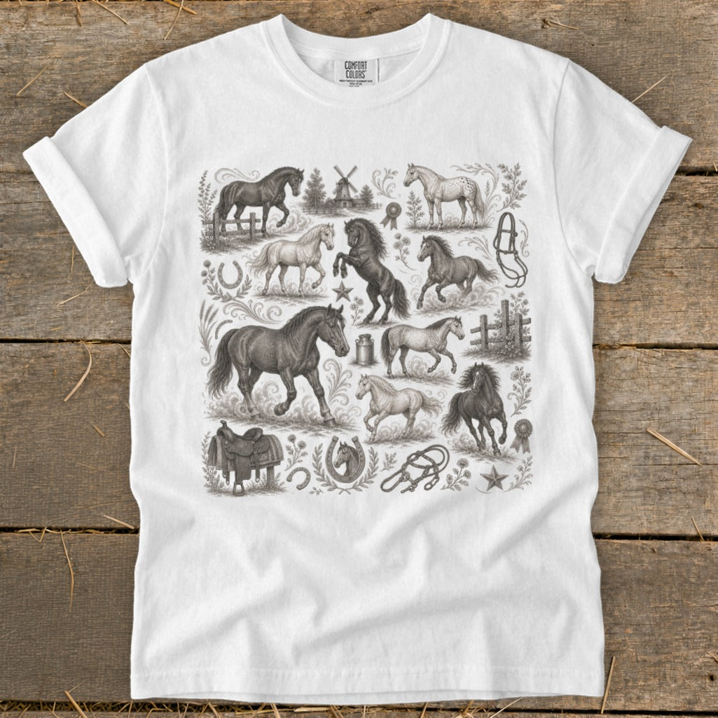 White t-shirt featuring a detailed, vintage-style pattern of horses and equestrian elements.