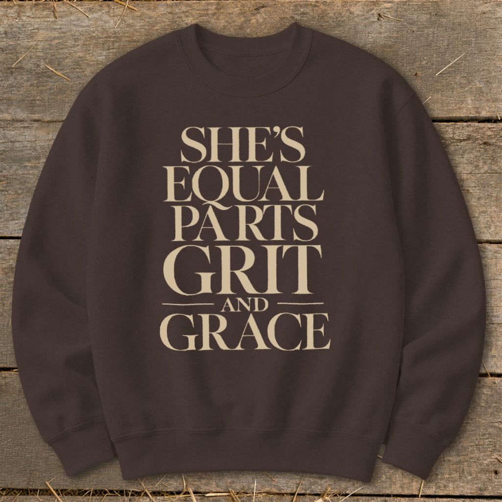 Brown sweatshirt with text "She's Equal Parts Grit and Grace" in cream.