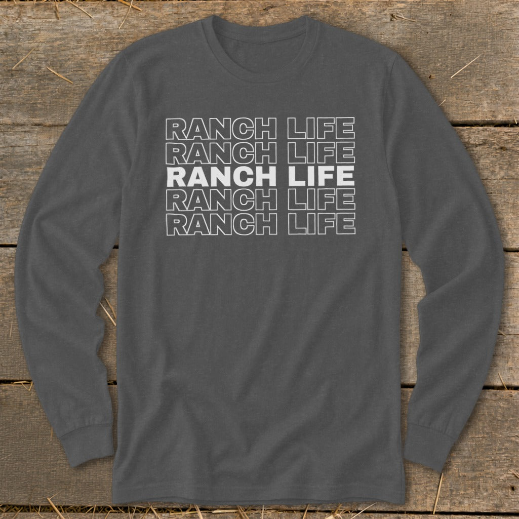 Dark gray long-sleeved crewneck t-shirt featuring stacked white text reading RANCH LIFE on a wooden background.