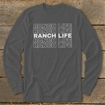 Dark gray long-sleeved crewneck t-shirt featuring stacked white text reading RANCH LIFE on a wooden background.