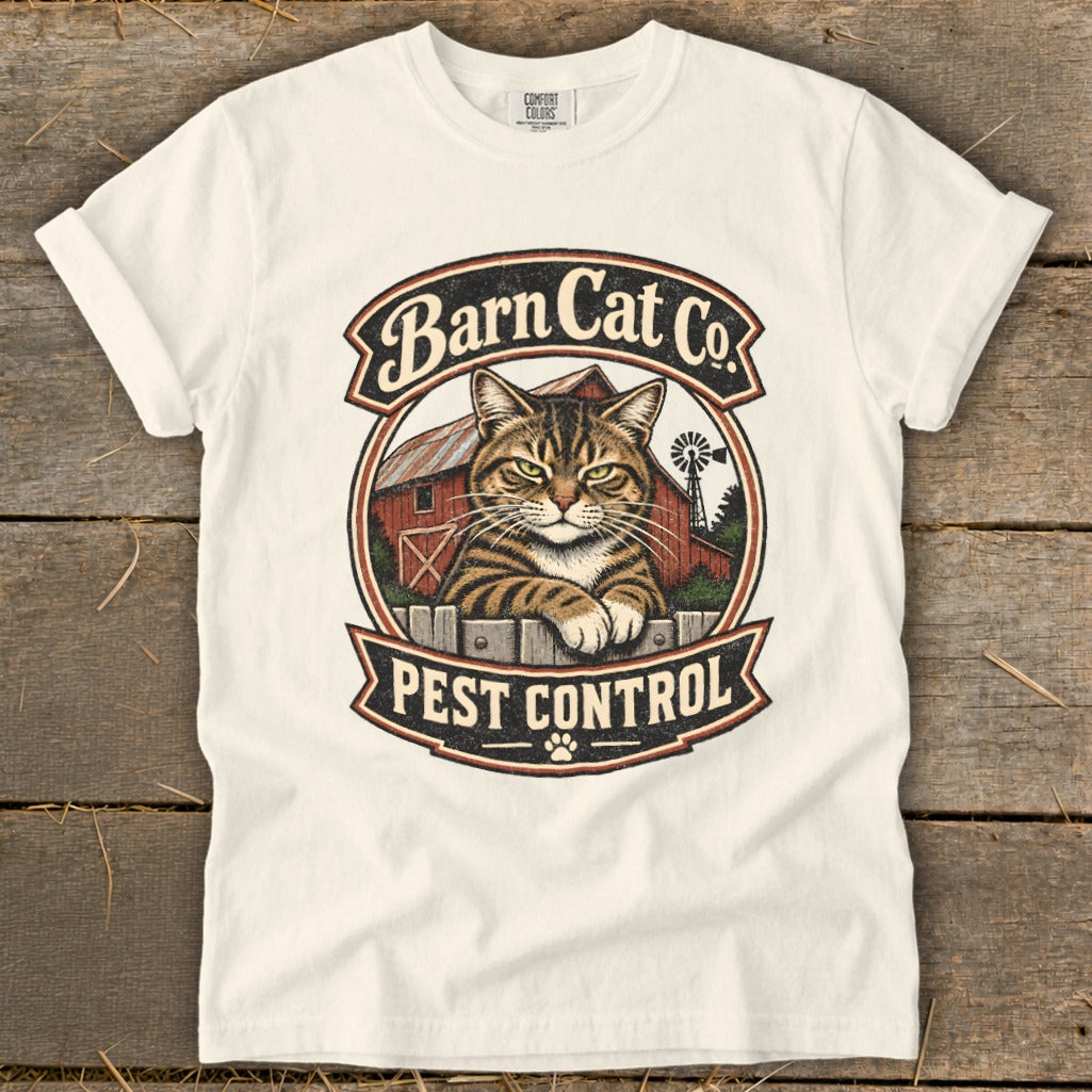 Off-white t-shirt featuring a vintage graphic of a tabby cat, barn, windmill, and text reading Barn Cat Co. Pest Control.