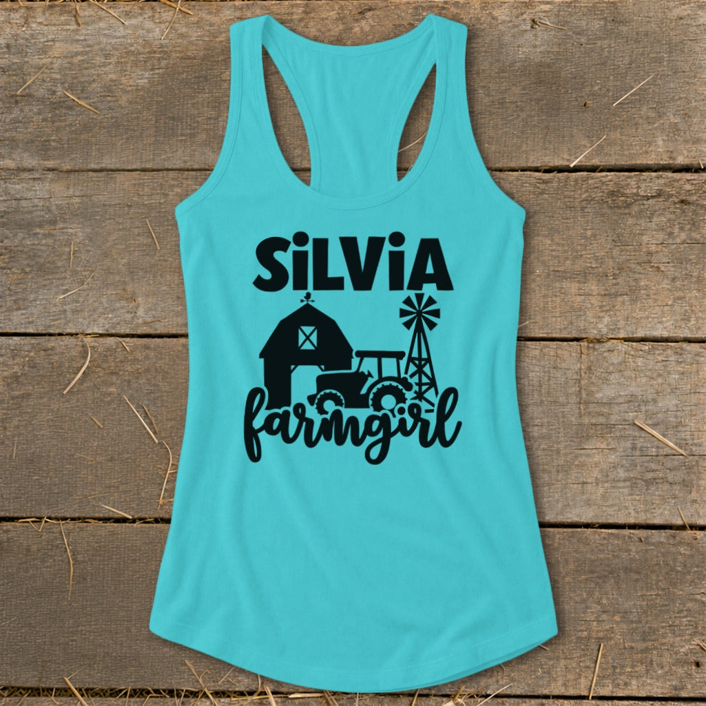 Turquoise tank top with black text and graphics of a barn, tractor, and windmill.