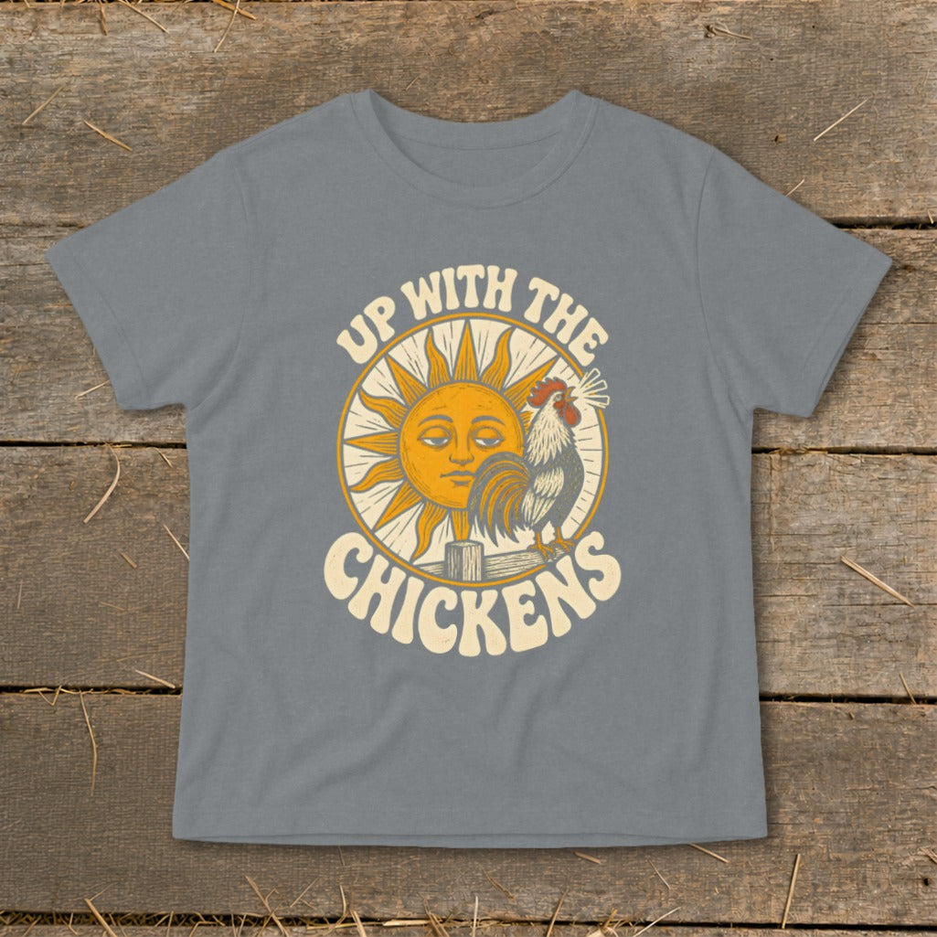 A grey t-shirt featuring a retro graphic of a rooster crowing beside a smiling sun with text reading Up With The Chickens.
