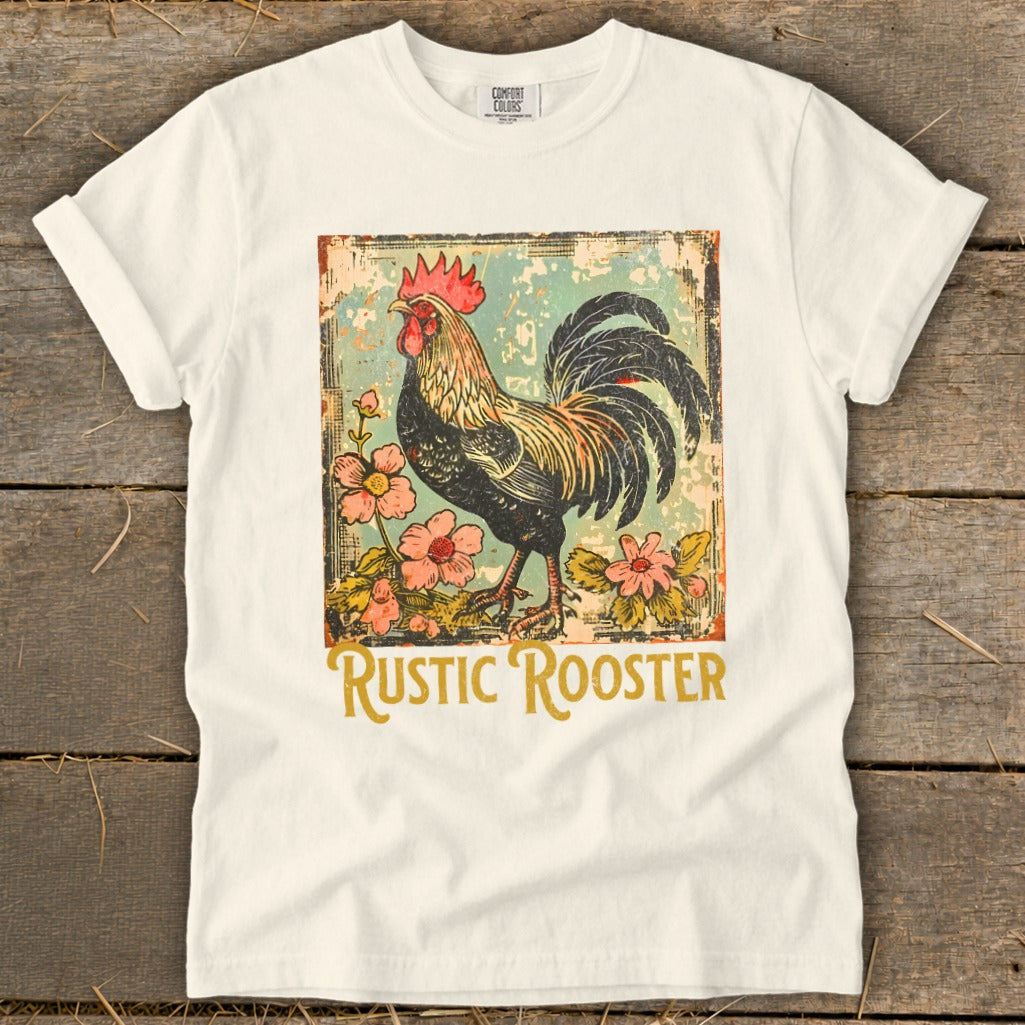 White t-shirt with a vintage-style rooster and flowers graphic that reads "Rustic Rooster".