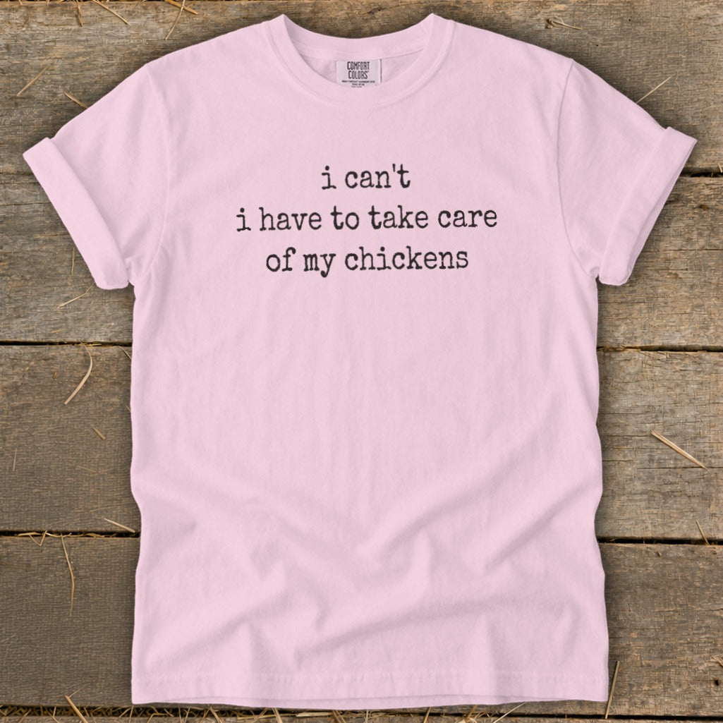 Light pink t-shirt with black text "i can't i have to take care of my chickens".
