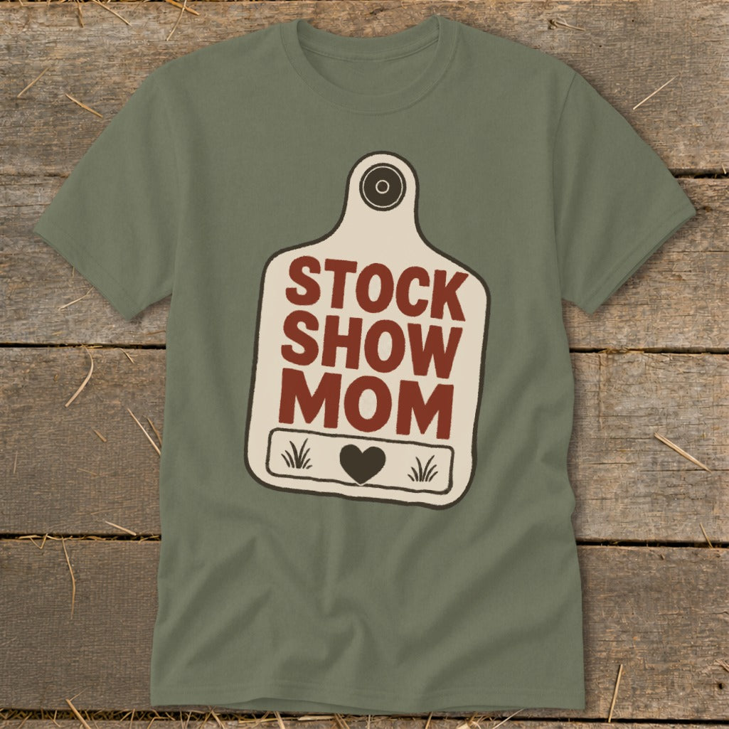 Green t-shirt with a cream-colored tag graphic that says "STOCK SHOW MOM".