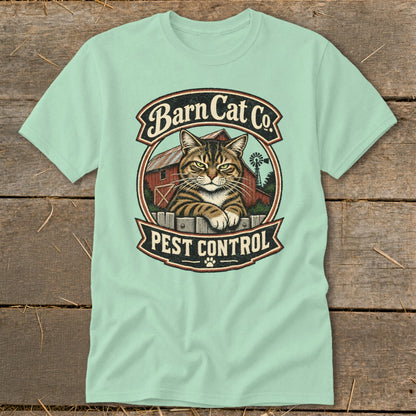 Light green t-shirt featuring a circular graphic with a tabby cat, red barn, and text reading Barn Cat Co. Pest Control.