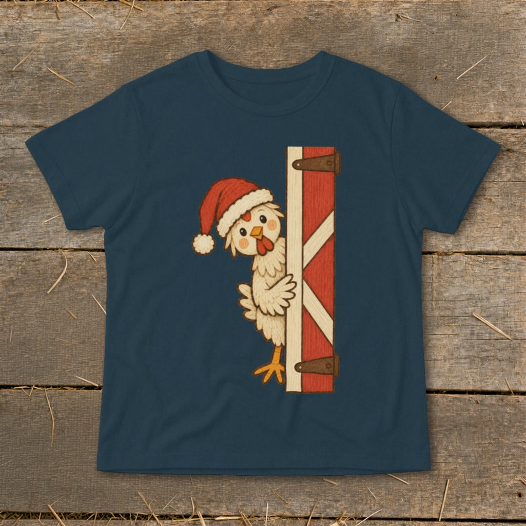 Chicken wearing Santa hat peeking around a barn door graphic on a navy t-shirt.