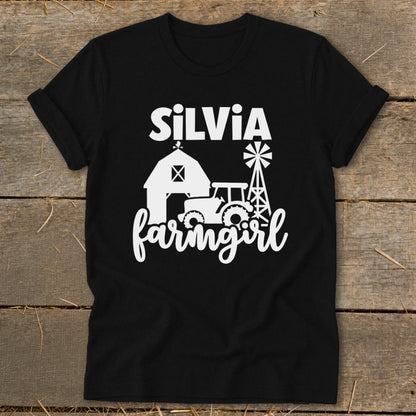 Black t-shirt with "Silvia farmgirl" text and farm scene graphic.