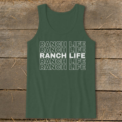 A dark green tank top laid flat on a weathered wooden surface, featuring the stacked white text "RANCH LIFE" repeated five times, with the middle line in solid white and the others in outline font.