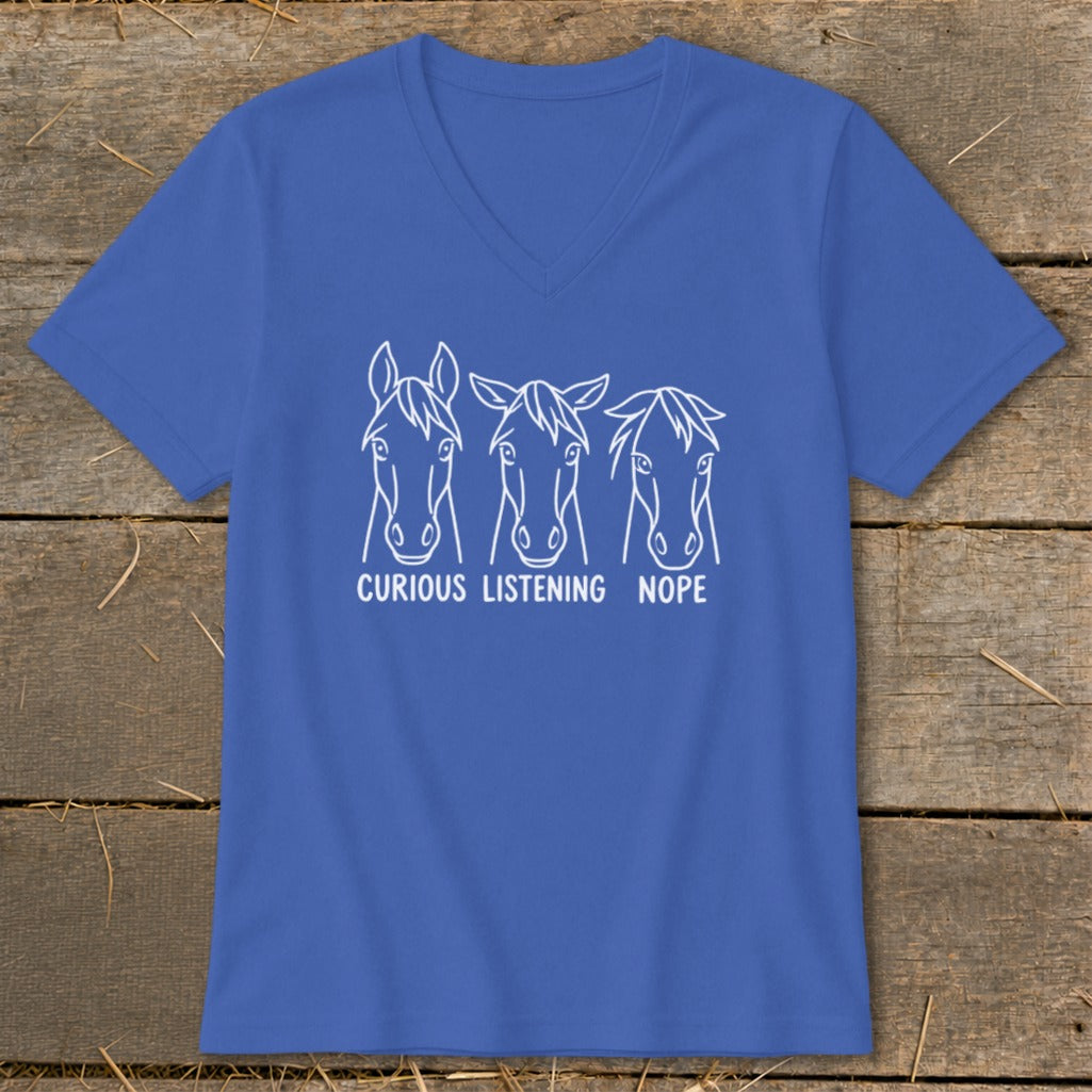 A blue V-neck t-shirt featuring three horse heads with the text "CURIOUS LISTENING NOPE" below them.