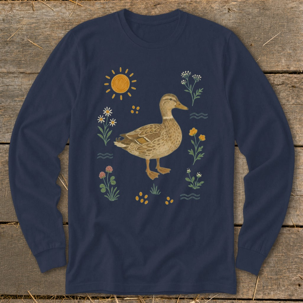 Long sleeve navy t-shirt with a watercolor mallard duck surrounded by wildflowers and sun.