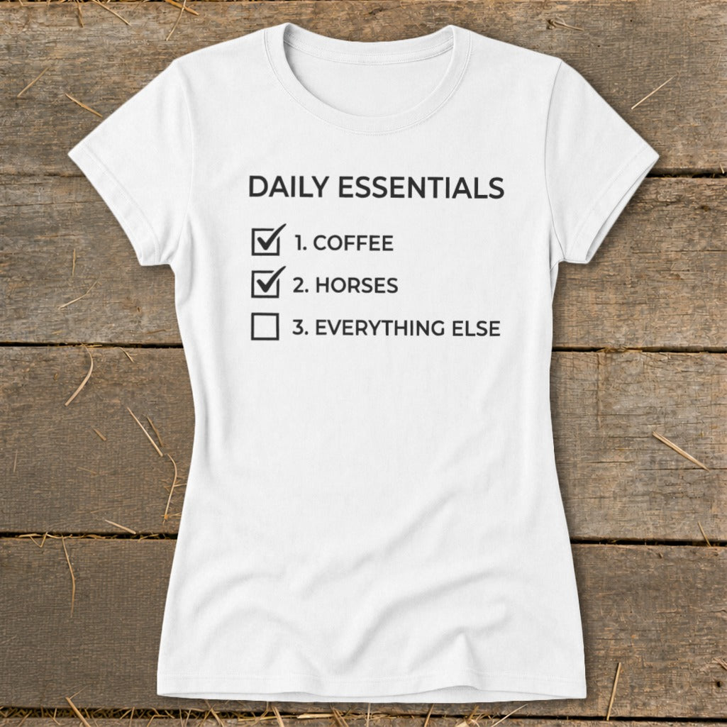 White t-shirt with "Daily Essentials" list: 1. Coffee, 2. Horses, 3. Everything Else.