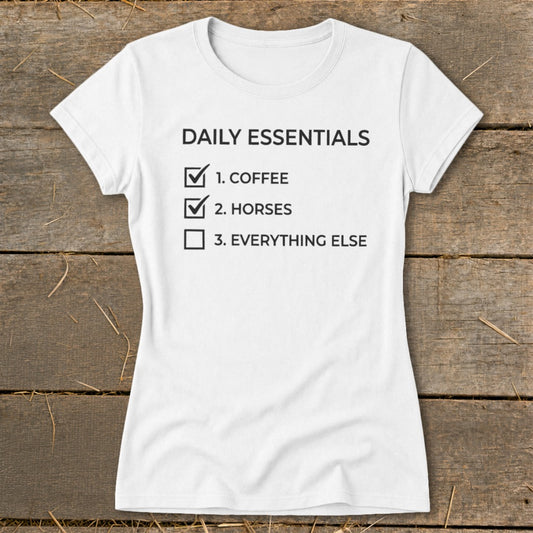 White t-shirt with "Daily Essentials" list: 1. Coffee, 2. Horses, 3. Everything Else.