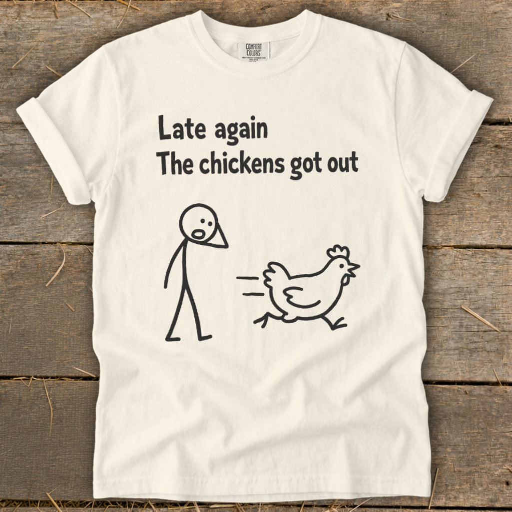 White t-shirt with black text and cartoon drawing of a person and a running chicken.