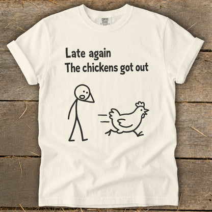 White t-shirt with black text and cartoon drawing of a person and a running chicken.