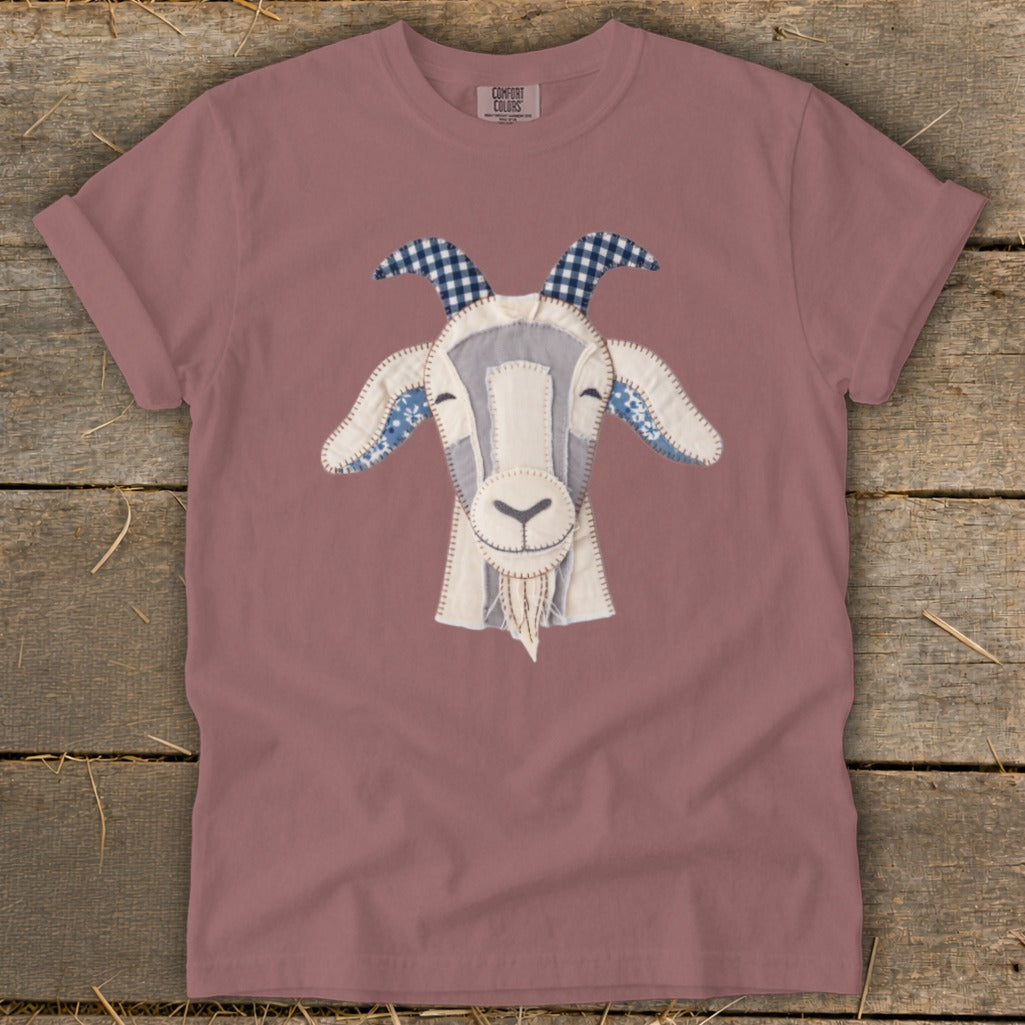 Rose-colored t-shirt with a stitched goat face applique and "COMFORT COLORS" tag.