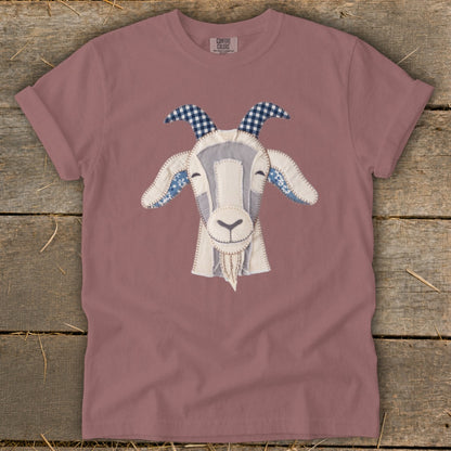 Rose-colored t-shirt with a stitched goat face applique and "COMFORT COLORS" tag.