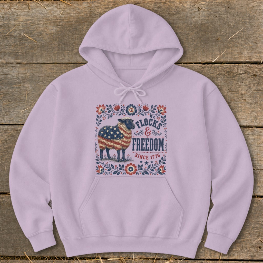 Light purple hoodie with sheep graphic featuring American flag, "Flocks & Freedom Since 1776."