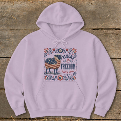 Light purple hoodie with sheep graphic featuring American flag, "Flocks & Freedom Since 1776."