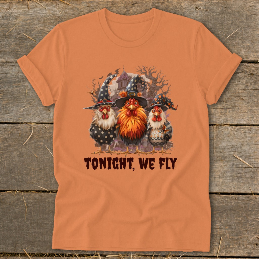 Three chickens in witch hats with "TONIGHT, WE FLY" text on an orange shirt.
