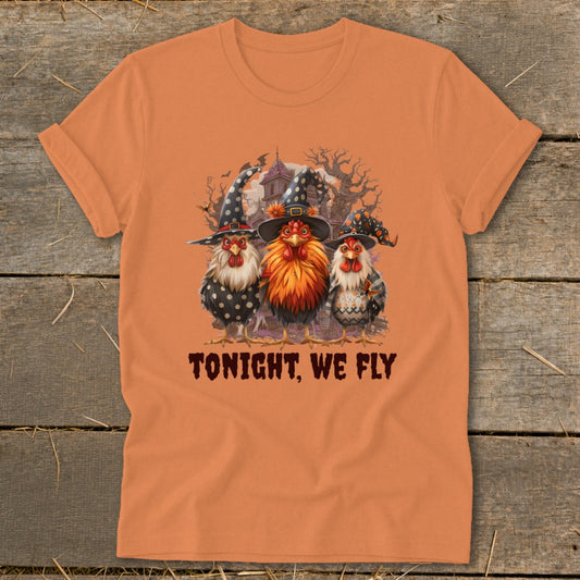 Three chickens in witch hats with "TONIGHT, WE FLY" text on an orange shirt.